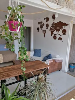 a room with a table and a map on the wall at PALMA 3 in Port-la-Nouvelle