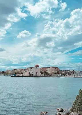 a large body of water with buildings in the background at Studio COSY à deux pas de la PLAGE ! in Gruissan