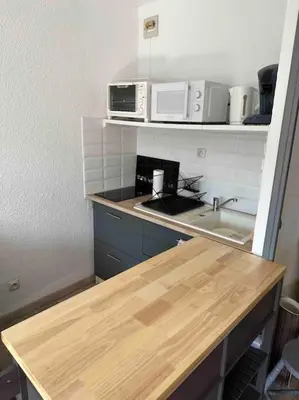 a kitchen with a counter top and a sink at Studio COSY à deux pas de la PLAGE ! in Gruissan
