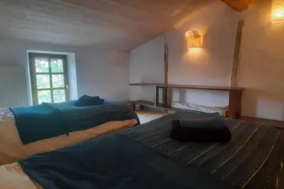a bedroom with two beds and a window at Charme Zen Ecrin de verdure Fraîcheur Spa in Pezens