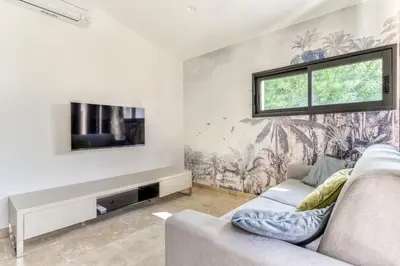 a living room with a couch and a tv at L'appenti in Luc-sur-Orbieu