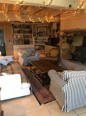 a living room with couches and a table and a fireplace at Villa - Mas de campagne prestigieux- Authentic french countryhouse in dream countryside in Algans