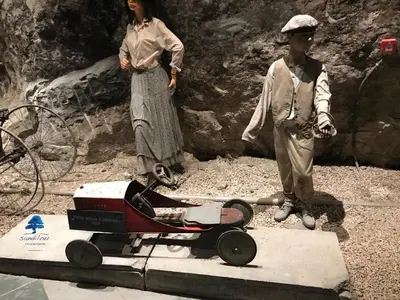 two dolls are standing next to a wheelbarrow at Mobilhome «Aux Portes du Soleil» in Sigean