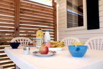 a table with fruit and milk on top of it at Mobilhome «Aux Portes du Soleil» in Sigean