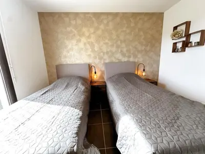 two beds sitting next to each other in a bedroom at Panorama in Rieux-Minervois