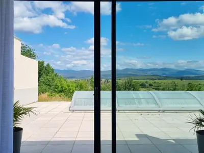 a view from the window of a house with a swimming pool at Panorama in Rieux-Minervois
