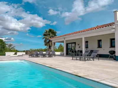 a swimming pool with chairs and a house at Panorama in Rieux-Minervois
