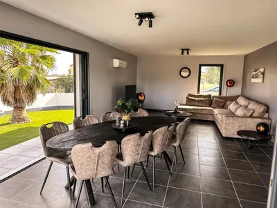 a living room with a table and chairs and a couch at Panorama in Rieux-Minervois