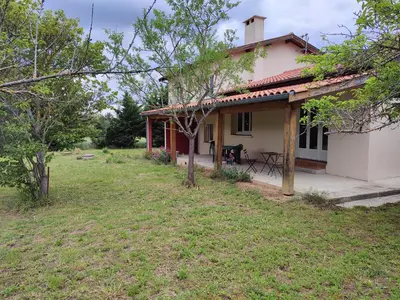 a small white house with a table in the yard at La Fontaine in Montgaillard-Lauragais