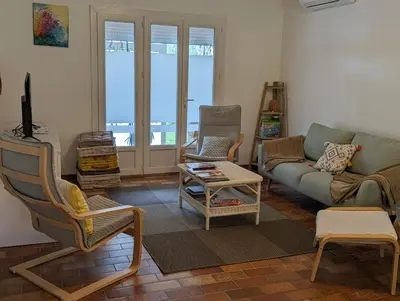 a living room with a couch and a chair at La Fontaine in Montgaillard-Lauragais