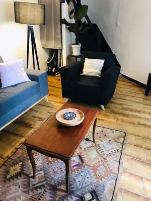 a living room with a blue couch and a coffee table at Gîte des Canelles in Villespy