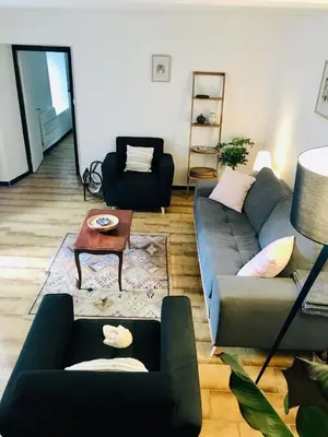 a living room with a couch and a table at Gîte des Canelles in Villespy