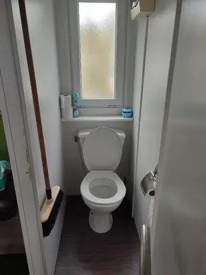 a small bathroom with a toilet and a window at Mobil home in Port-la-Nouvelle