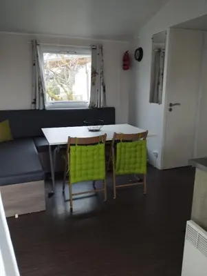 a kitchen and dining room with a table and chairs at Mobil home in Port-la-Nouvelle