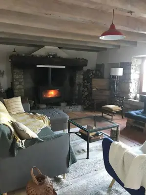a living room with a couch and a fireplace at Maison en pierre dans le Sidobre in Le Bez