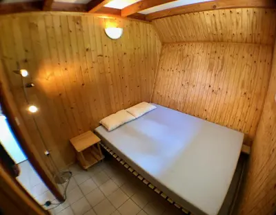 a small room with a bed in a sauna at Chalet dans le parc d'un manoir du XIXème in Anglès