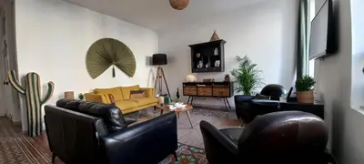 a living room with leather furniture and a yellow couch at La maison de Malaurie in Gruissan