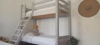 a bedroom with a bunk bed and a ladder at La maison de Malaurie in Gruissan