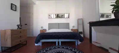 a bedroom with a bed and a dresser in it at La maison de Malaurie in Gruissan