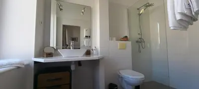 a bathroom with a sink and a toilet and a shower at La maison de Malaurie in Gruissan
