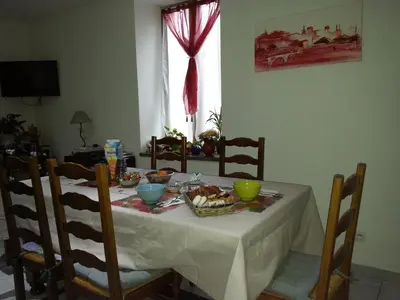 a dining room table with a white table cloth and food on it at Millot Conilhac in Conilhac-Corbières
