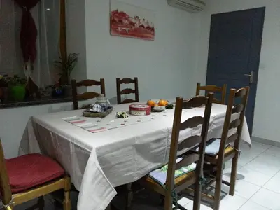 a dining room table with a white table cloth on it at Millot Conilhac in Conilhac-Corbières