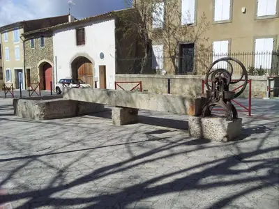 a stone bench in the middle of a street at Millot Conilhac in Conilhac-Corbières