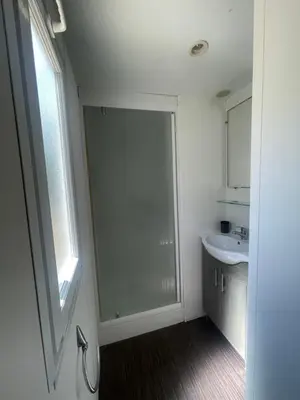 a bathroom with a shower and a sink at Mobil Home de Marine in Port-la-Nouvelle