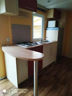 a kitchen with a wooden counter top in a room at Mobil home au bord du lac in Nages
