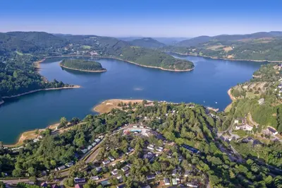an aerial view of a lake with houses and trees at Mobil home au bord du lac in Nages