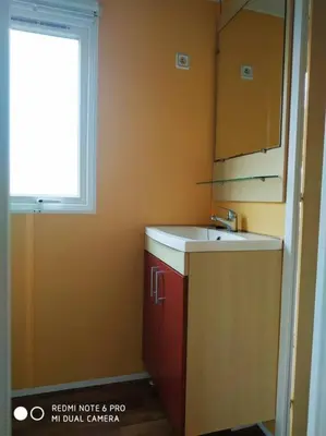 a small kitchen with a sink and a window at Mobil home au bord du lac in Nages