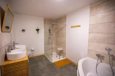 a bathroom with a tub and a sink and a shower at Gîte du Montagut in Thézan-des-Corbières