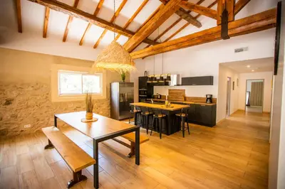 a kitchen and dining room with a table and chairs at Gîte du Montagut in Thézan-des-Corbières