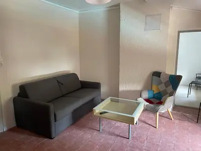 a living room with a couch and a coffee table at Douceur occitane in Saint-Chinian