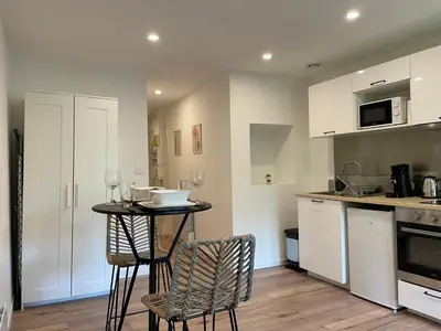 a kitchen with a table and chairs in a room at Studio Le Cilaos, au cœur de Castres in Castres