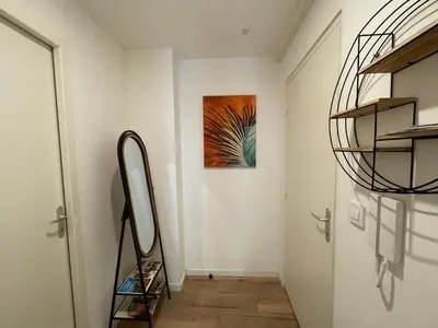 a hallway with a door and a painting on the wall at Studio Le Cilaos, au cœur de Castres in Castres