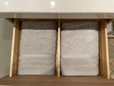 two sets of towels are stacked in a closet at Studio Le Cilaos, au cœur de Castres in Castres