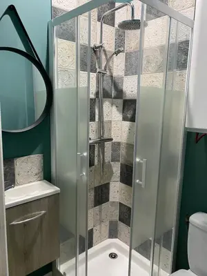 a shower with a glass door in a bathroom at Au pied du centre ville - Mignon petit studio climatisé in Narbonne