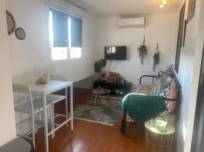 a living room with a couch and a table at Proche des plages - Beau T2 climatisé in Narbonne