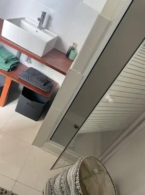 a bathroom with a sink and a mirror at Proche des plages - Beau T2 climatisé in Narbonne