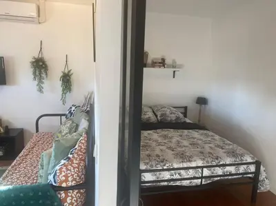 a bedroom with a bed and a mirror at Proche des plages - Beau T2 climatisé in Narbonne