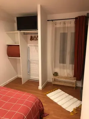a room with a bed and a window and a television at Charmant T2 climatisé - Près des plages in Narbonne