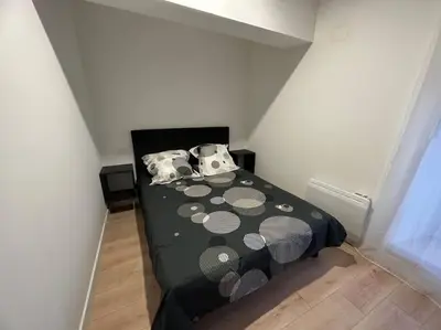 a small bedroom with a black bed with polka dots at Chez Gaëlle in Trèbes