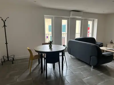 a living room with a table and a couch at La Casa de Gaëlle 2 in Trèbes