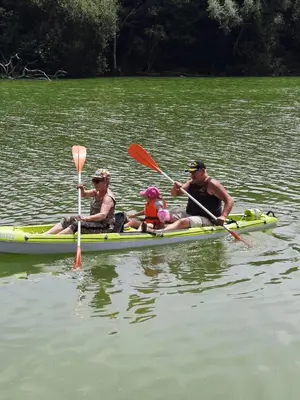 a group of people in a kayak on the water at demeure de charme in Mazères