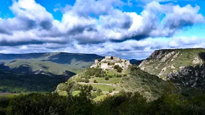 a castle on top of a mountain in the mountains at Gîtes à la Ferme - Hautes-Corbières in Termes