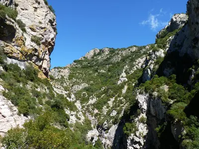 a view of a rocky mountain with green vegetation at Gîtes à la Ferme - Hautes-Corbières in Termes
