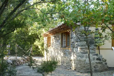 a stone house in the middle of a forest at Gîtes à la Ferme - Hautes-Corbières in Termes