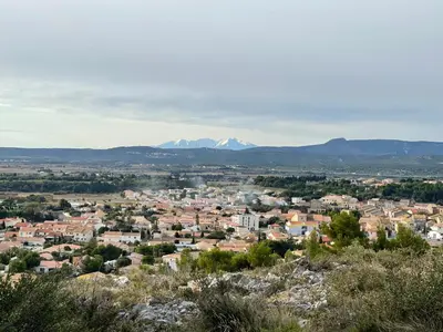 a view of a city with mountains in the background at Duplex proche mer, avec swimspa terrasse, jardin et barbecue in Lapalme
