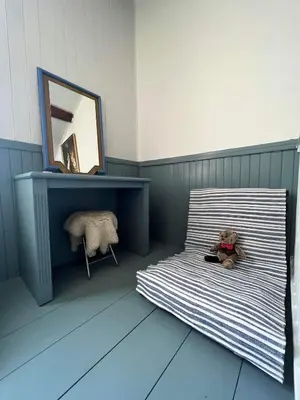 a teddy bear sitting on a bed in a room at Duplex proche mer, avec swimspa terrasse, jardin et barbecue in Lapalme